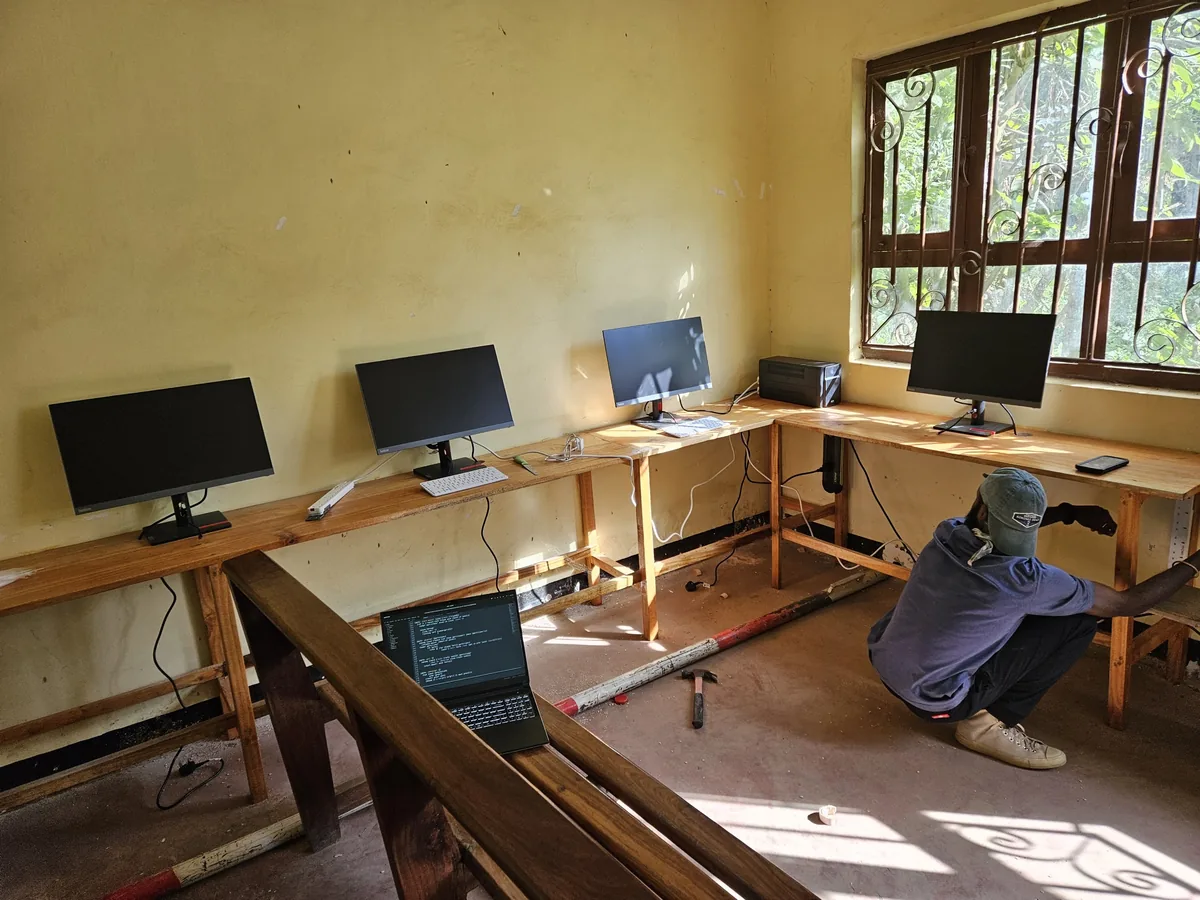 Cables being installed in the Kimundo room, with monitors on the desks.