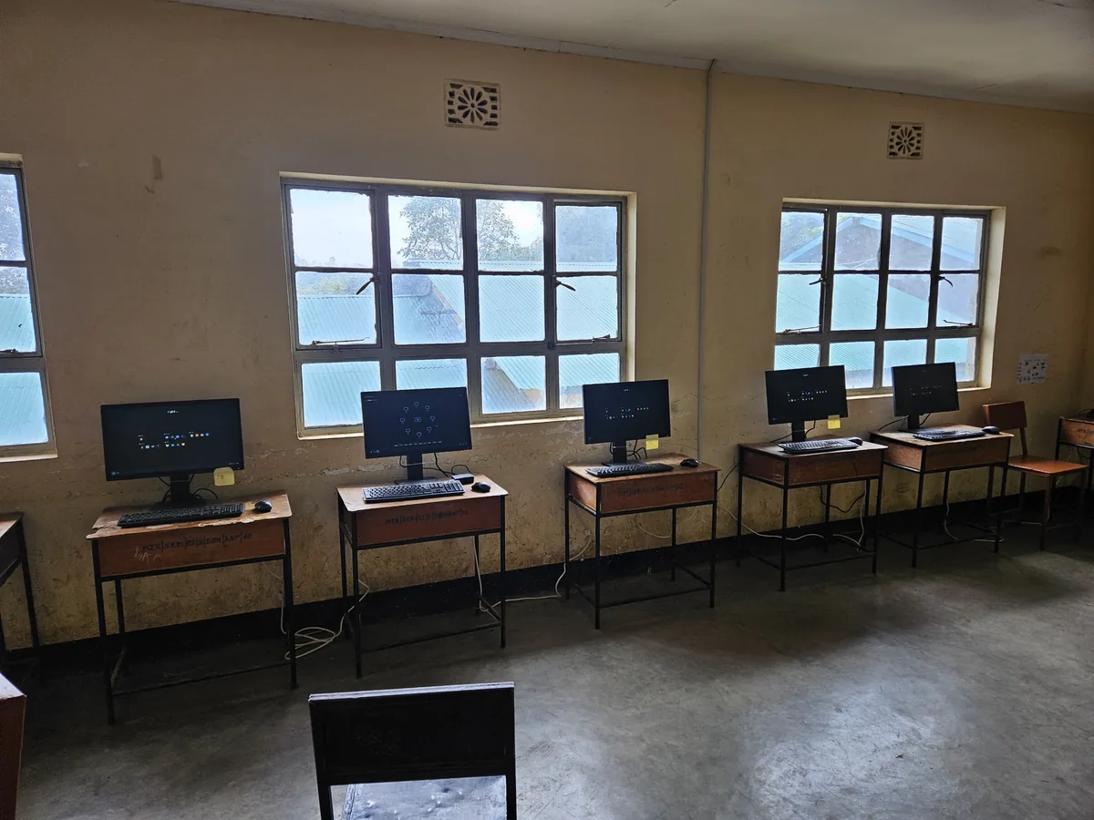 Workstations along the window wall of the Nkoarisambu lab, running UjimaOS.