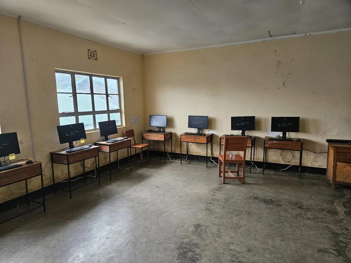 Workstations in the Nkoarisambu lab running UjimaOS, September 2026.