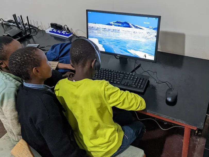 Two children sharing a workstation at Peace Matunda Primary School in 2023.